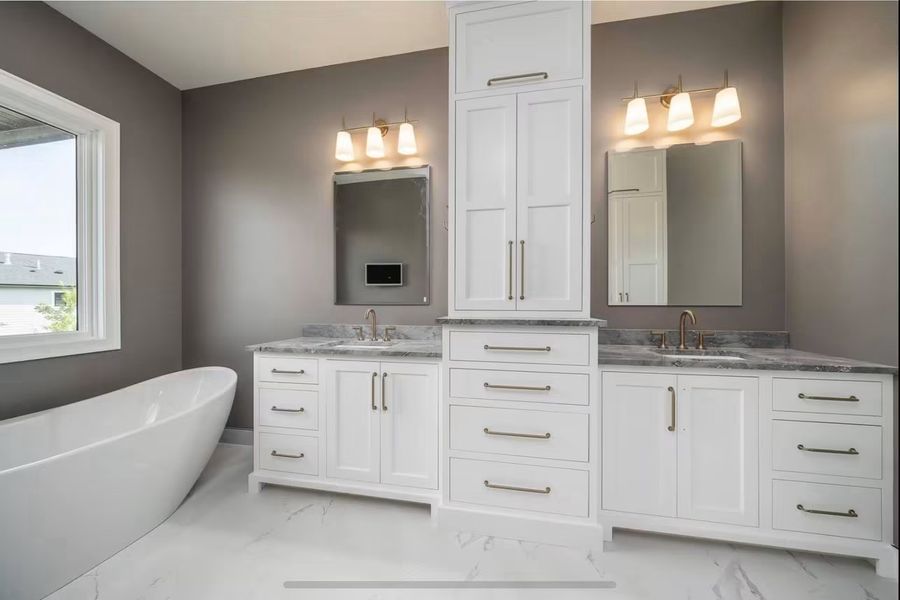Primary bath with split double vanity, tower storage and freestanding tub