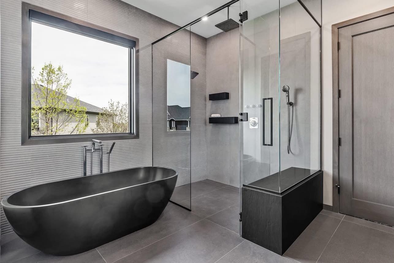 Primary bathroom with freestanding soaking tub and frameless glass shower