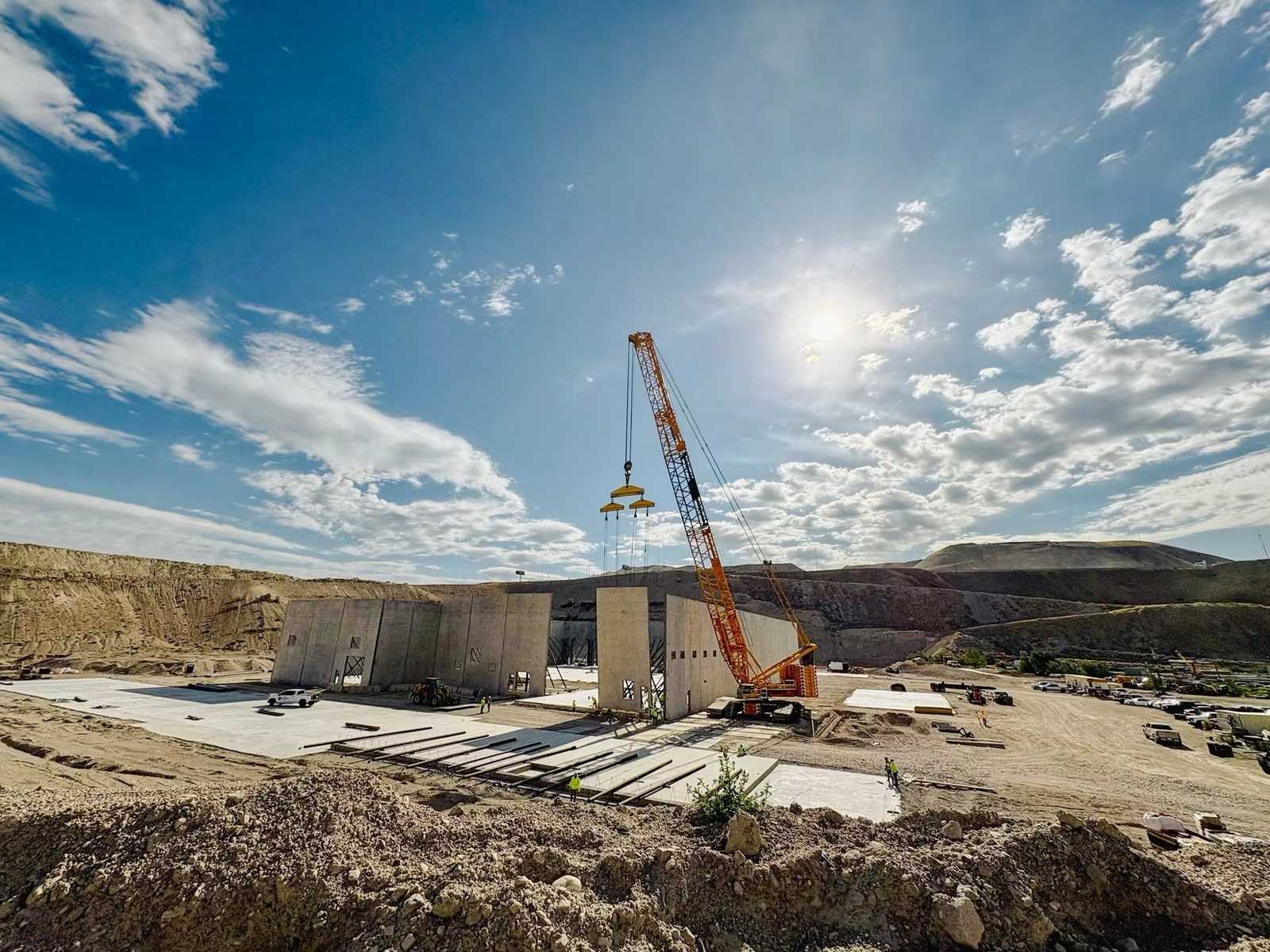 Commercial building pad and structure going up with a crawler crane on site