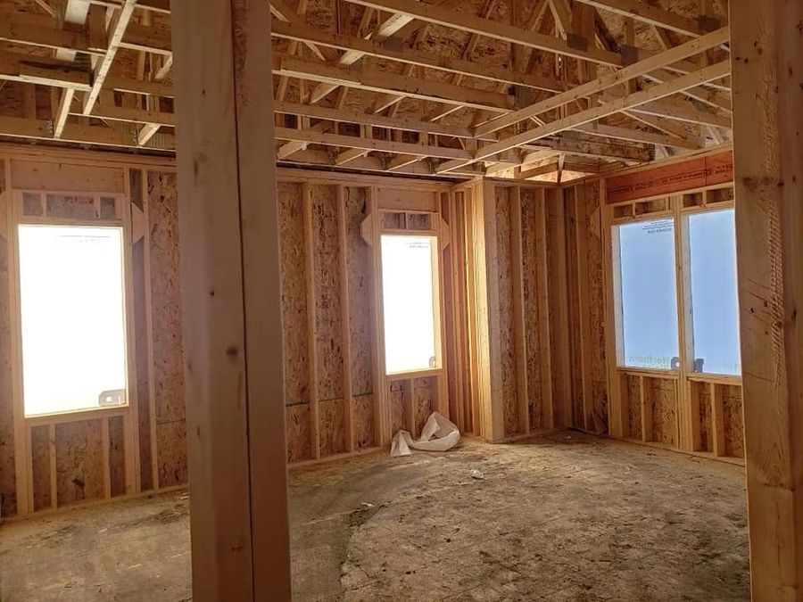Interior framing with structural posts and beams set on a lower level