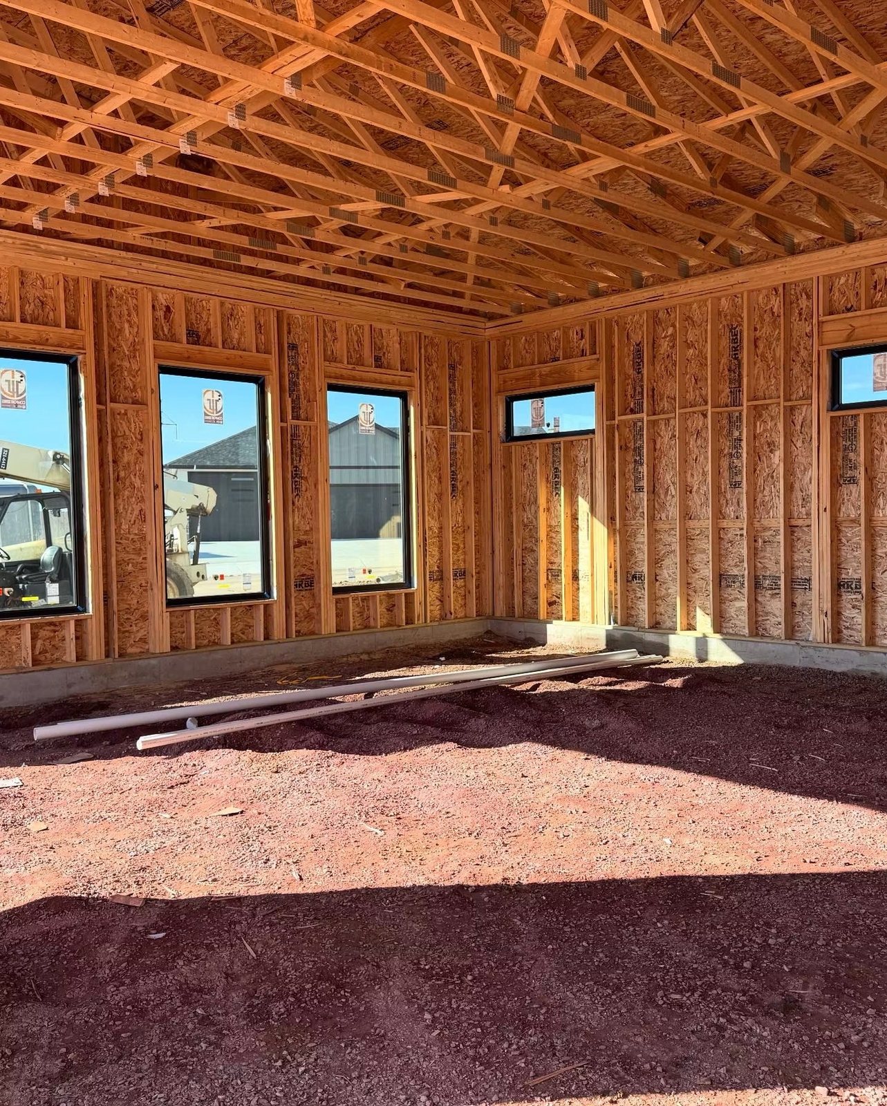Interior framing complete with roof trusses set and sheathing installed