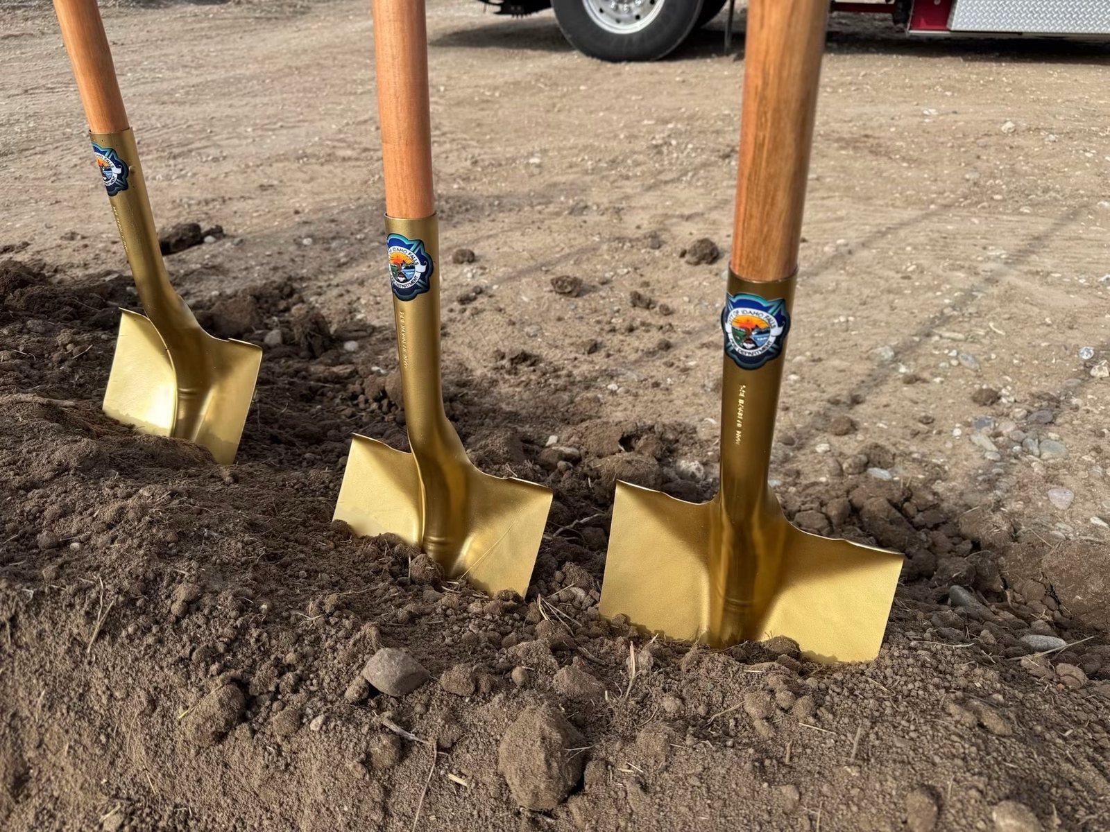 Groundbreaking shovels set in the dirt at the start of a project