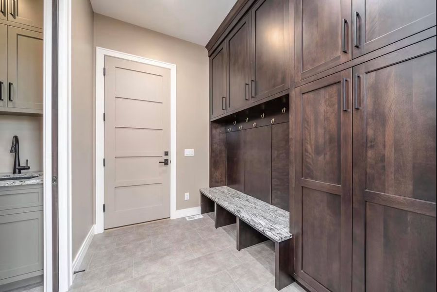 Mudroom with built-in lockers, bench seating and stained cabinetry