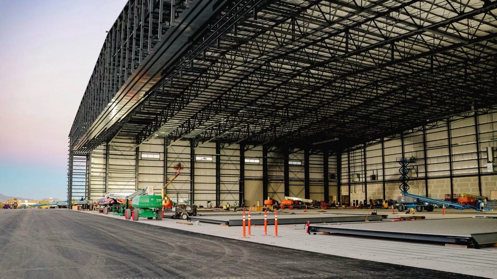 Large clear-span warehouse interior with the finished concrete slab poured